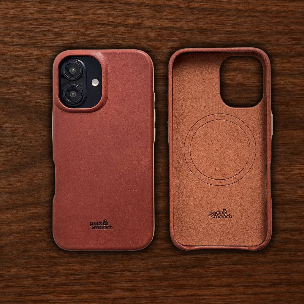 Light brown leather iPhone case on walnut, beside it the inside with its soft microfibre lining, model CHESTER
